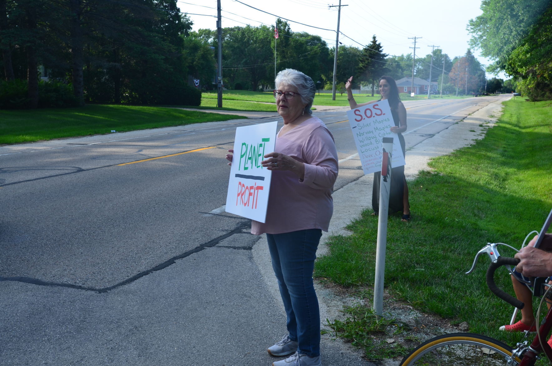 Protestors hold signs
